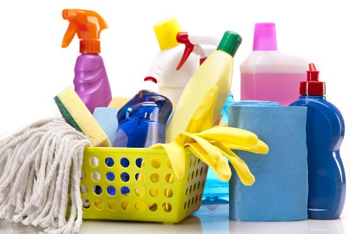Technician handling carpet cleaning chemicals with protective equipment